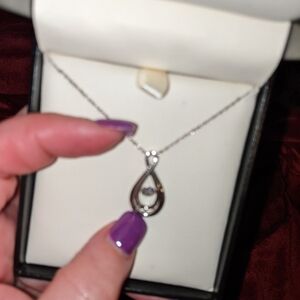 White gold pendant with a floating diamond